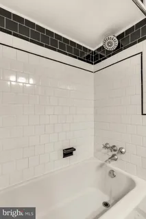 a bathroom with a bathtub and shower