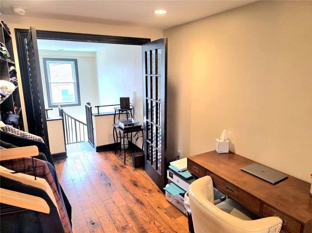 604 Middle Street Pittsburgh, PA 15212 - Photo 19 of 47 a bedroom with furniture and a wooden floor