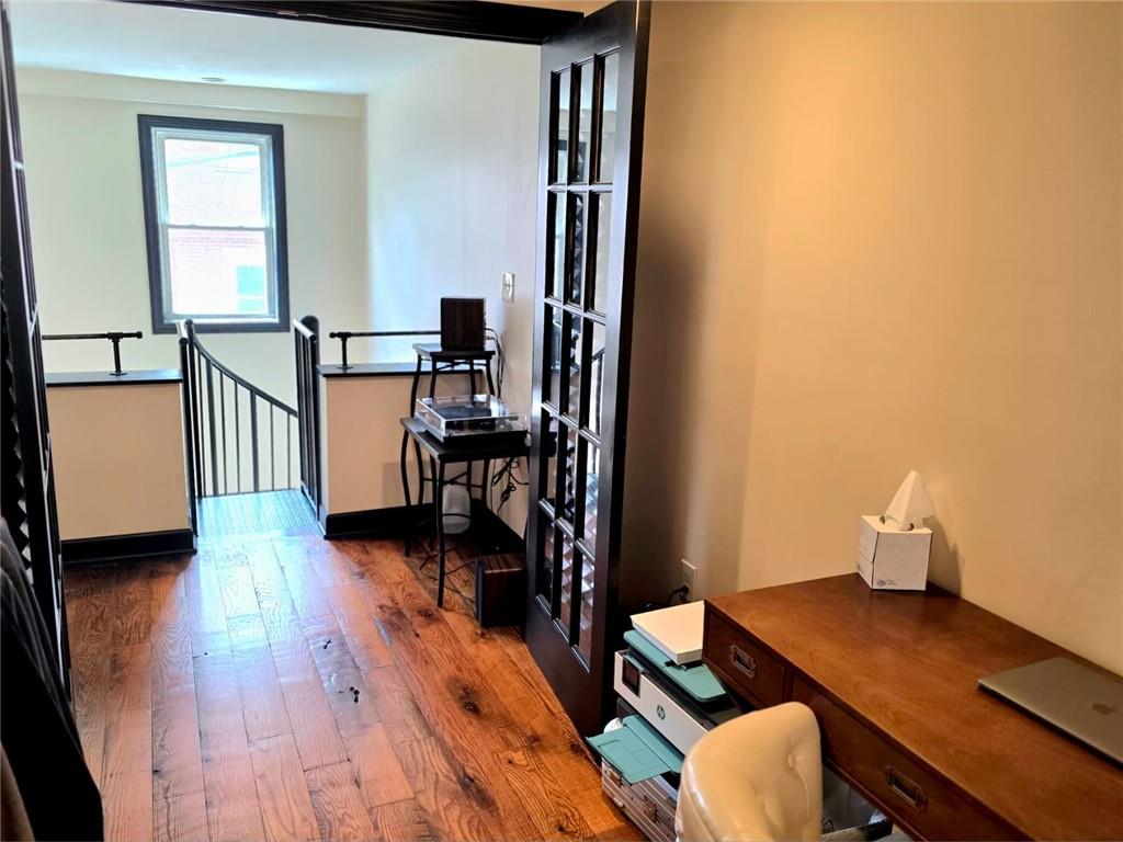 604 Middle Street Pittsburgh, PA 15212 - Photo 20 of 47 a view of a workspace with furniture and wooden floor