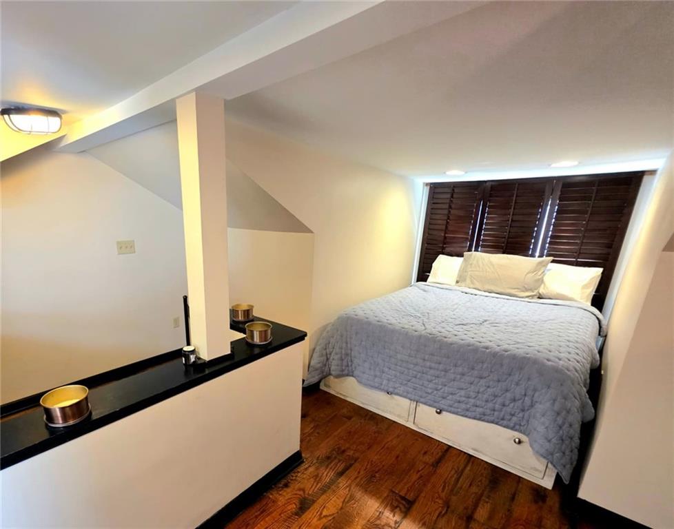 604 Middle Street Pittsburgh, PA 15212 - Photo 31 of 47 a bedroom with a bed and wooden floor