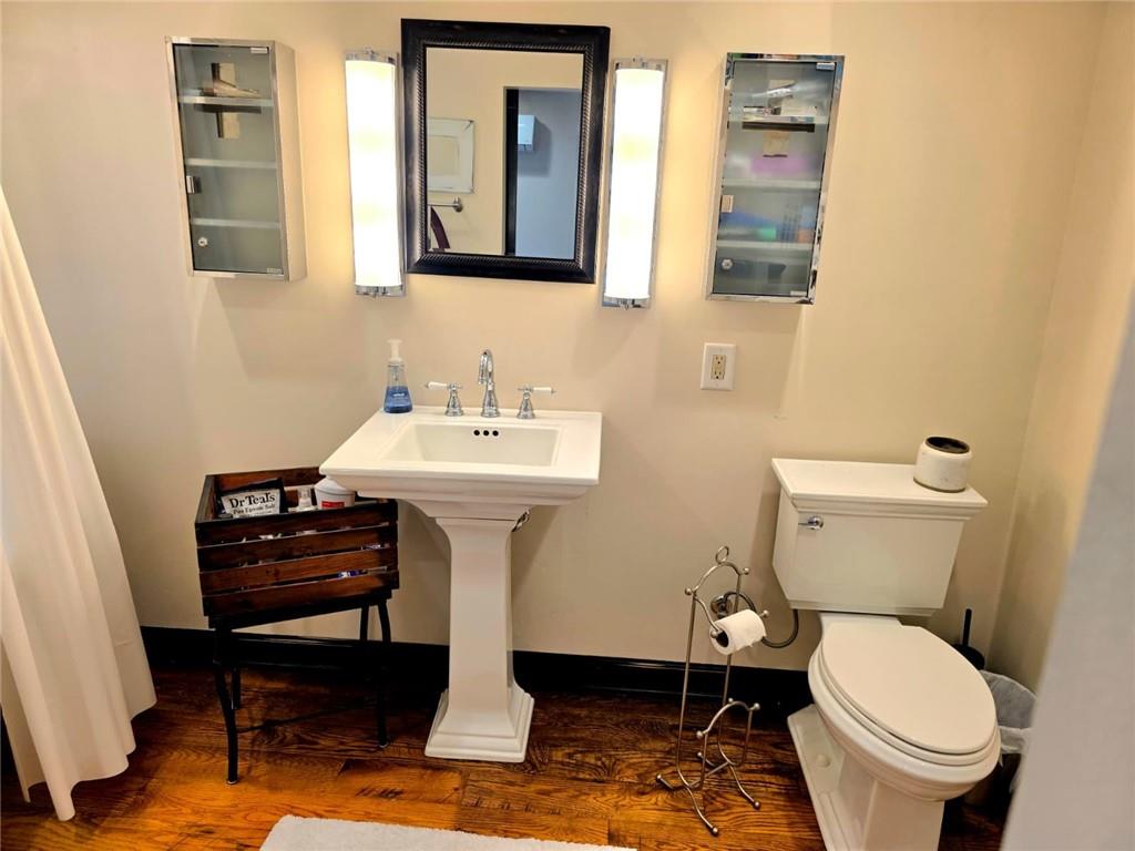 604 Middle Street Pittsburgh, PA 15212 - Photo 40 of 47 a bathroom with a sink a toilet and mirror