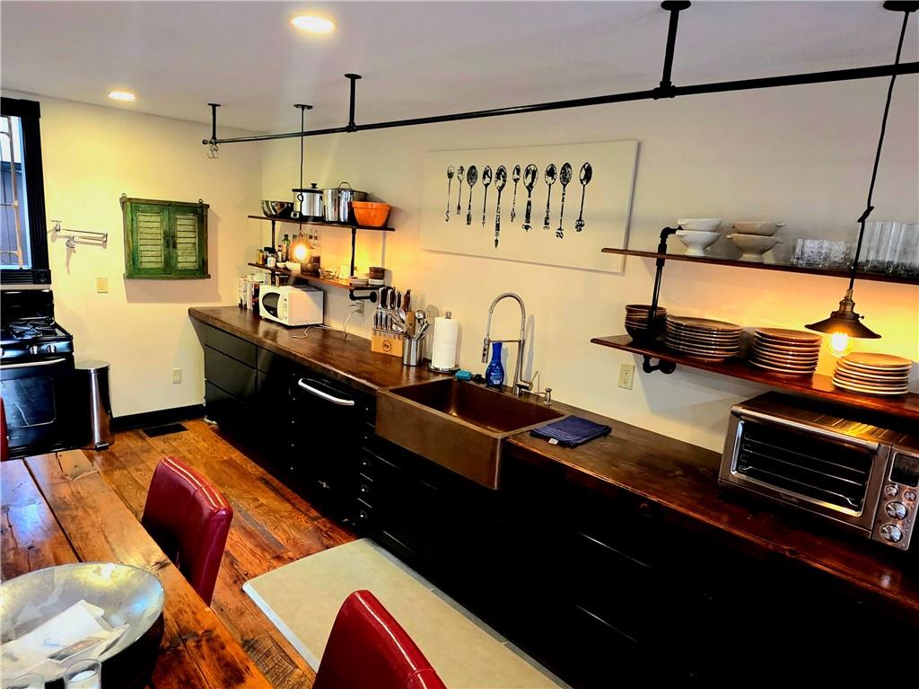 604 Middle Street Pittsburgh, PA 15212 - Photo 5 of 47 a kitchen with stainless steel appliances kitchen island granite countertop a stove a sink and a microwave