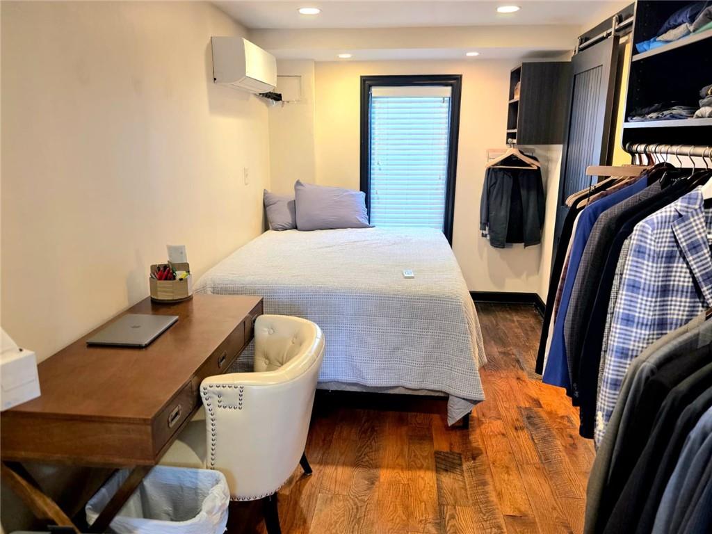 604 Middle Street Pittsburgh, PA 15212 - Photo 7 of 47 a bedroom with a bed and a television