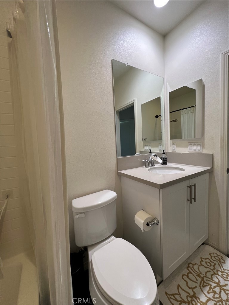 8282 Celestial Avenue Buena Park, CA 90621 - Photo 26 of 33 a bathroom with a toilet sink and mirror