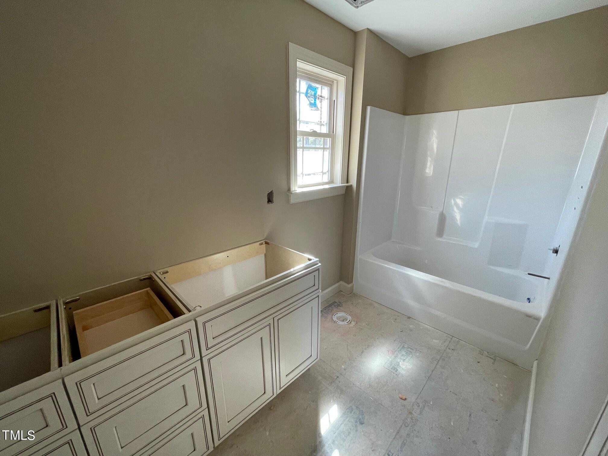 15 Young Road Angier, NC 27501 - Photo 8 of 13 a bathroom with double vanity and a bathtub