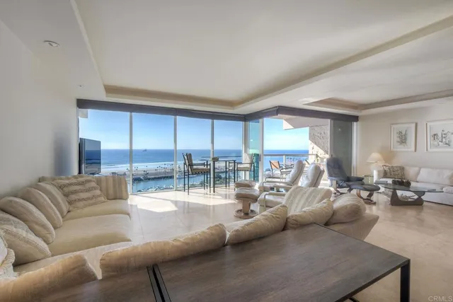 a living room with furniture a flat screen tv and kitchen view