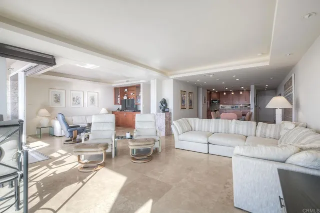 a living room with furniture and a kitchen