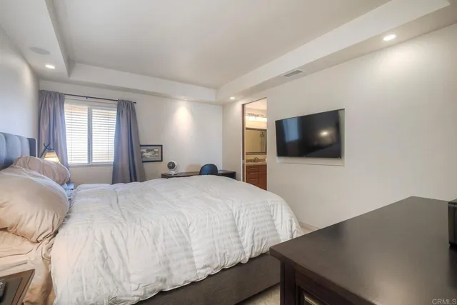 a bedroom with a bed and a flat screen tv