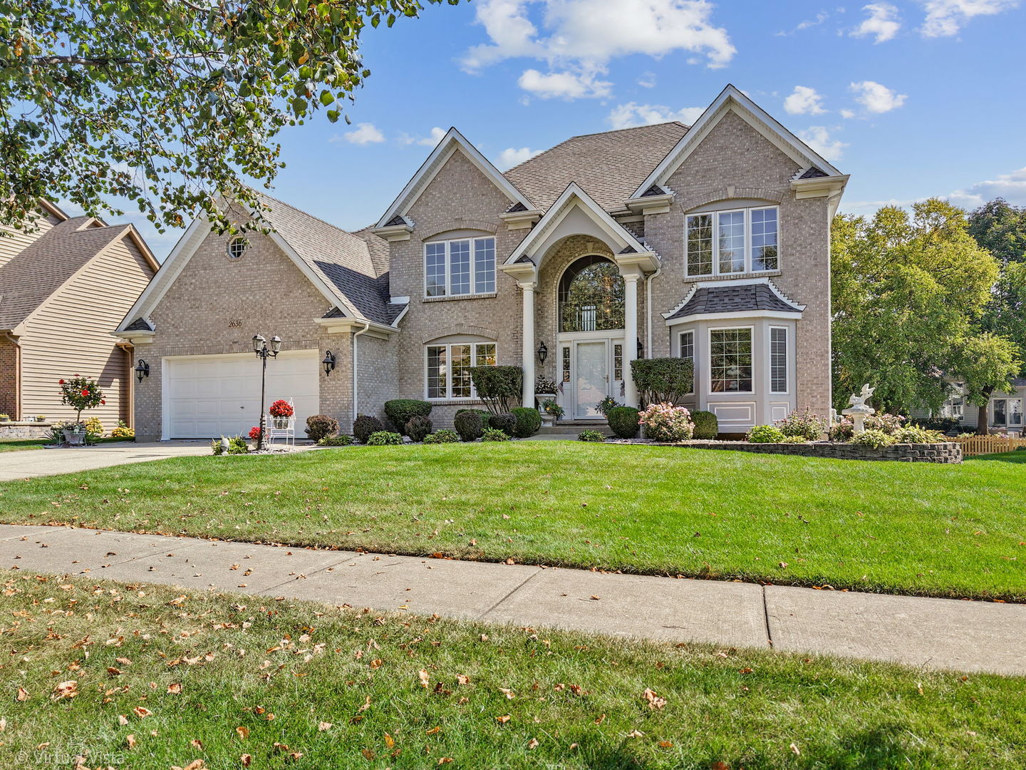 a front view of a house with a garden and plants