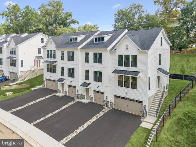 a view of a white house with a yard