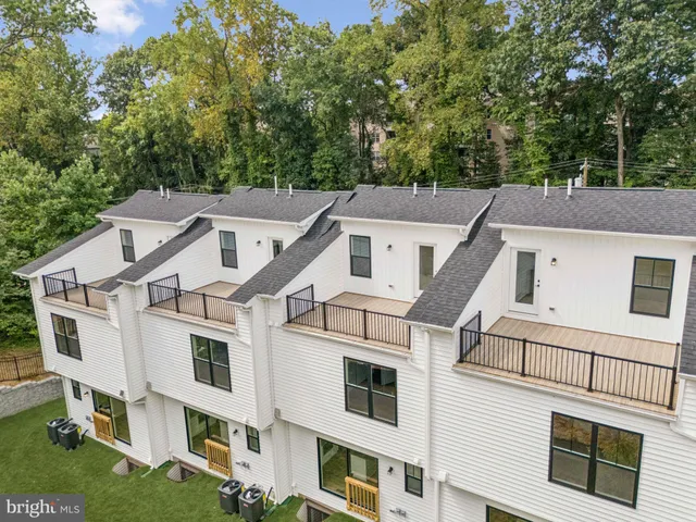 a aerial view of a white building with large windows