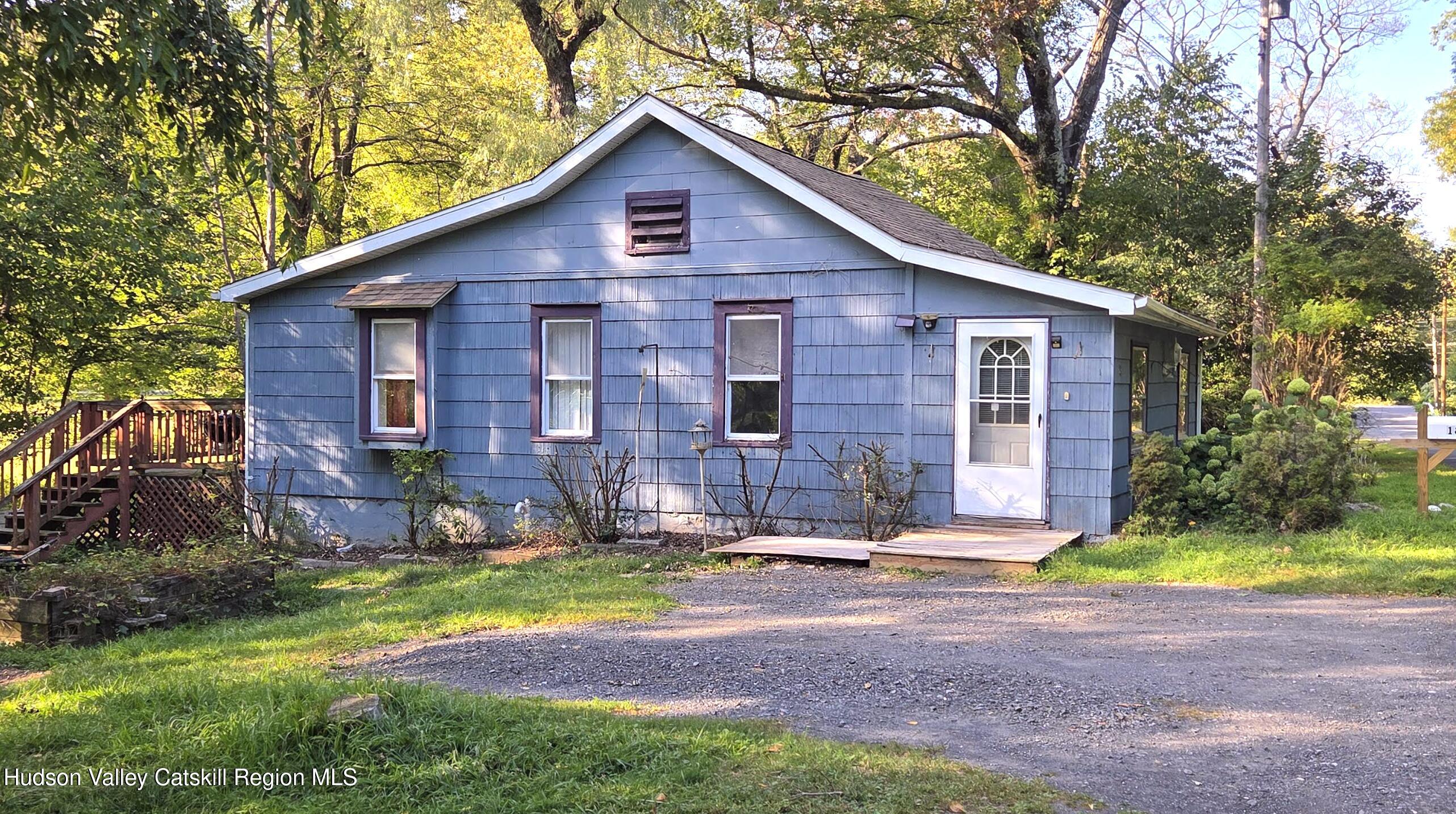 18 Kate Yaeger Road Saugerties, NY 12477 - Photo 3 of 16 a view of a yard in front of a house with plants and large tree