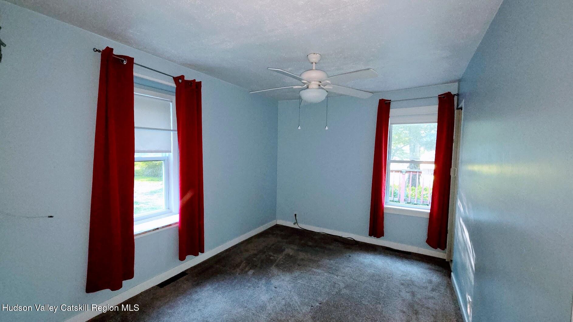 18 Kate Yaeger Road Saugerties, NY 12477 - Photo 9 of 16 an empty room with windows and fan