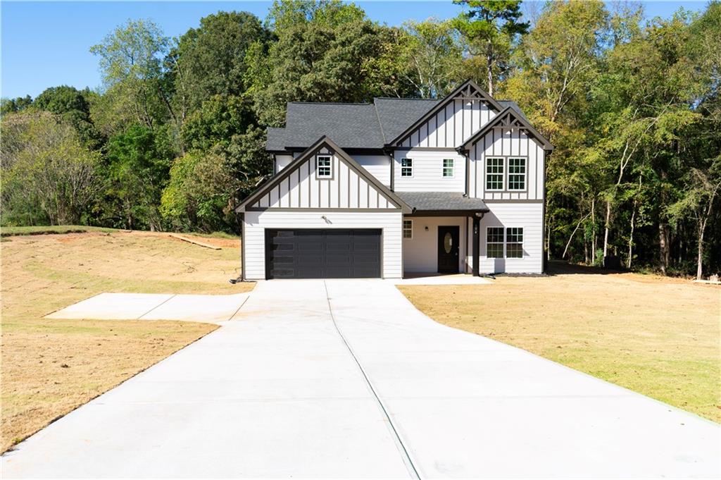 654 B B Wilson Road Commerce, GA 30529 - Photo 1 of 1 a front view of a house with a yard and garage
