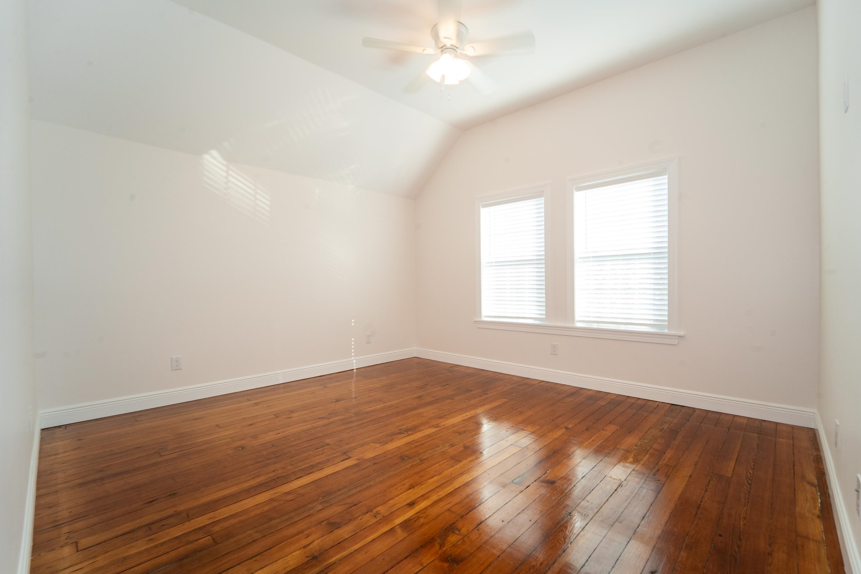 11 Aviles Street, Unit 2D St. Augustine, FL 32084 - Photo 13 of 24 an empty room with wooden floor and windows