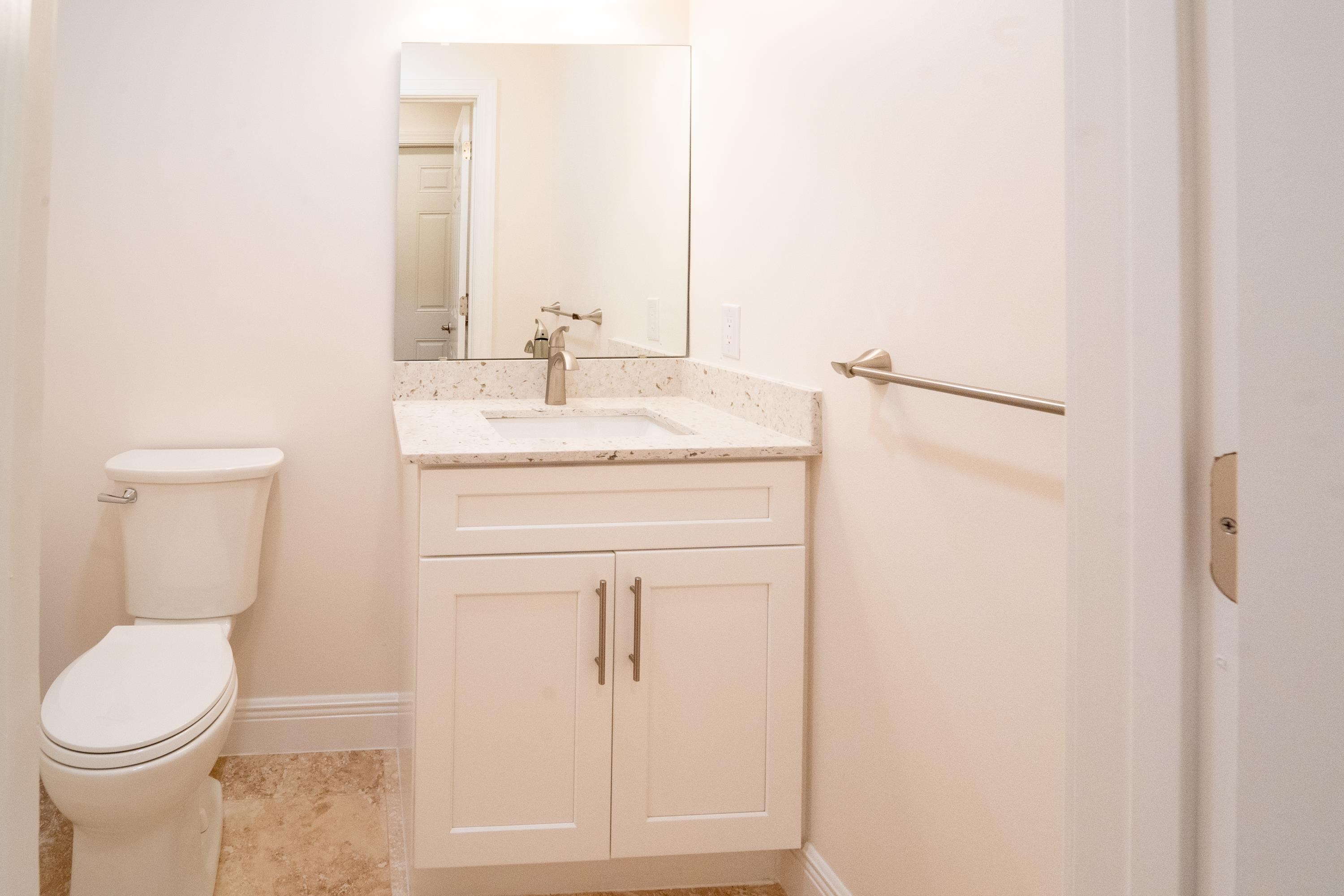 11 Aviles Street, Unit 2D St. Augustine, FL 32084 - Photo 20 of 24 a bathroom with a sink a toilet and vanity