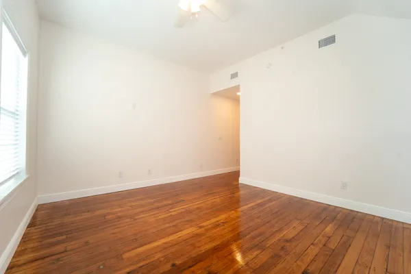 a view of a hallway with stainless steel appliances granite countertop a refrigerator