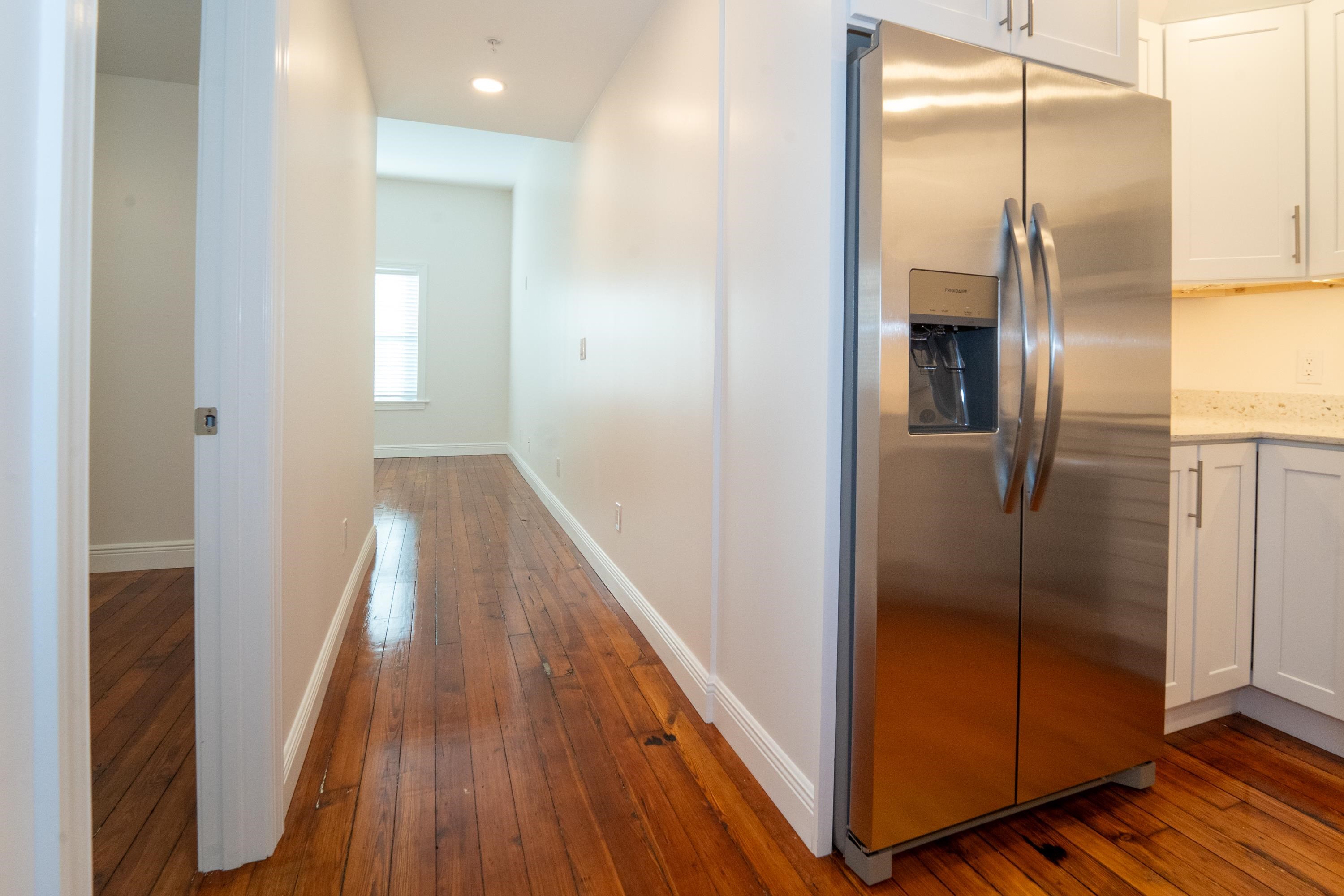 11 Aviles Street, Unit 2D St. Augustine, FL 32084 - Photo 5 of 24 a view of a hallway with stainless steel appliances granite countertop a refrigerator