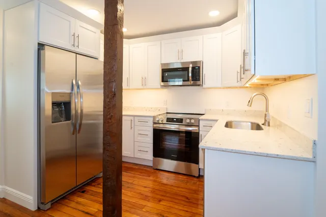 a kitchen with a refrigerator stove and microwave