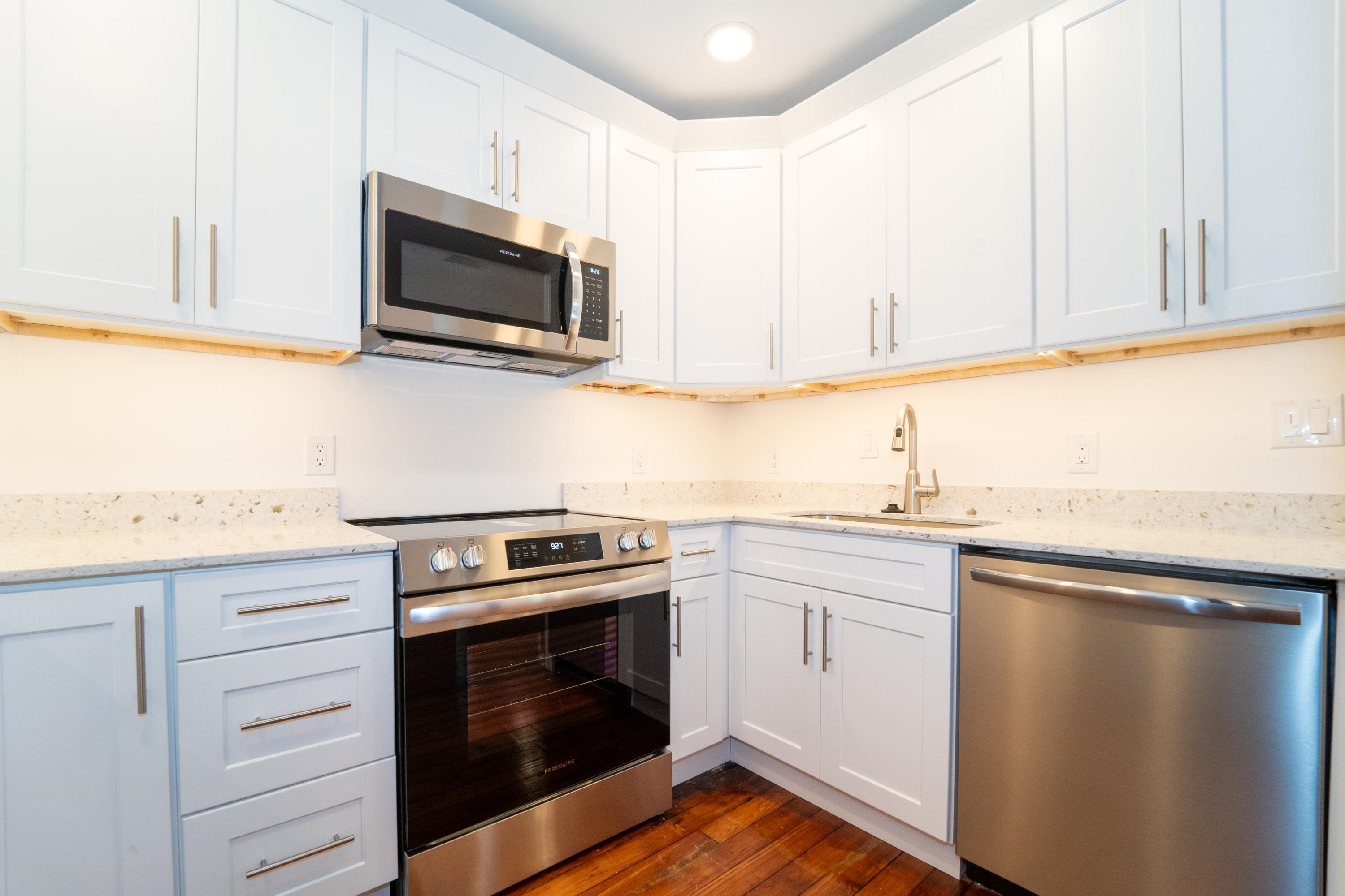 11 Aviles Street, Unit 2D St. Augustine, FL 32084 - Photo 9 of 24 a kitchen with granite countertop white cabinets stainless steel appliances and sink