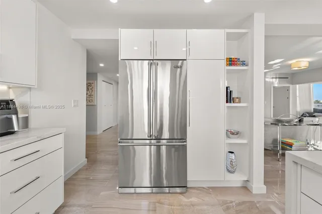a living room with furniture a flat screen tv and a floor to ceiling window