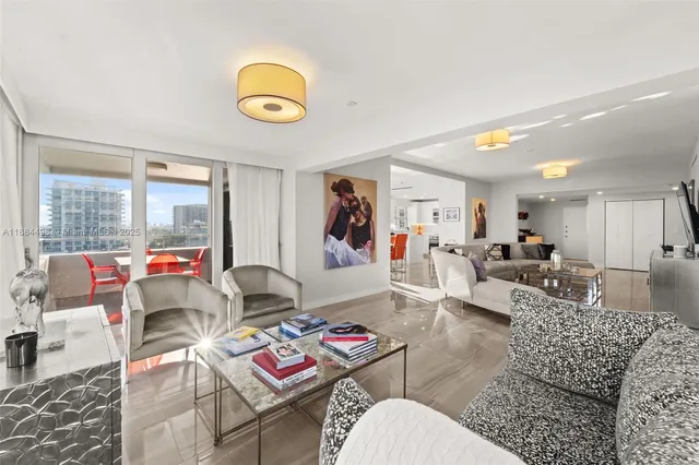 a living room with furniture and a view of kitchen