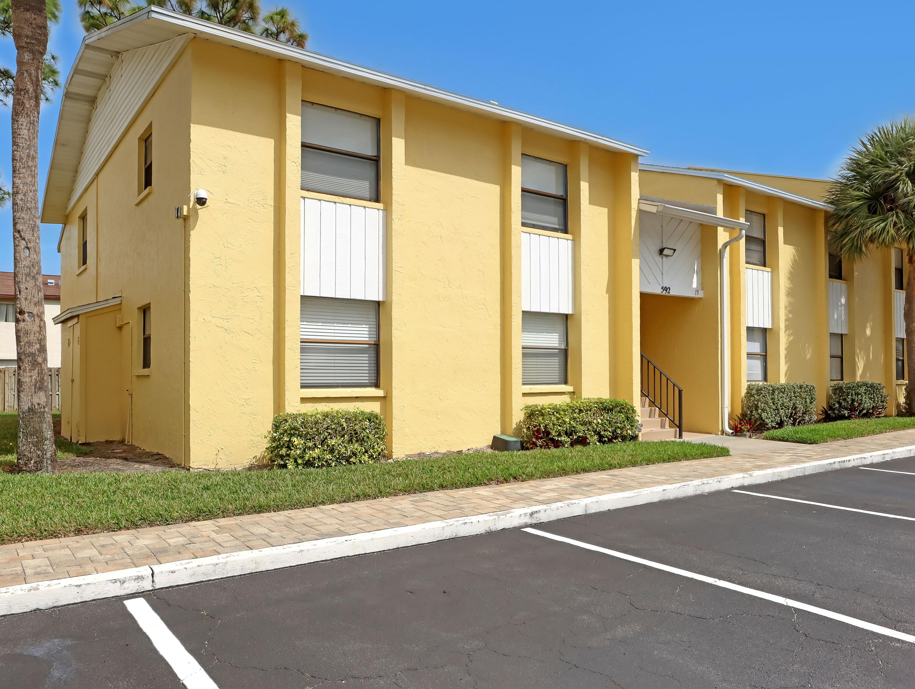 592 North Wickham Road, Unit 18 Melbourne, FL 32935 - Photo 1 of 29 a front view of a house having yard