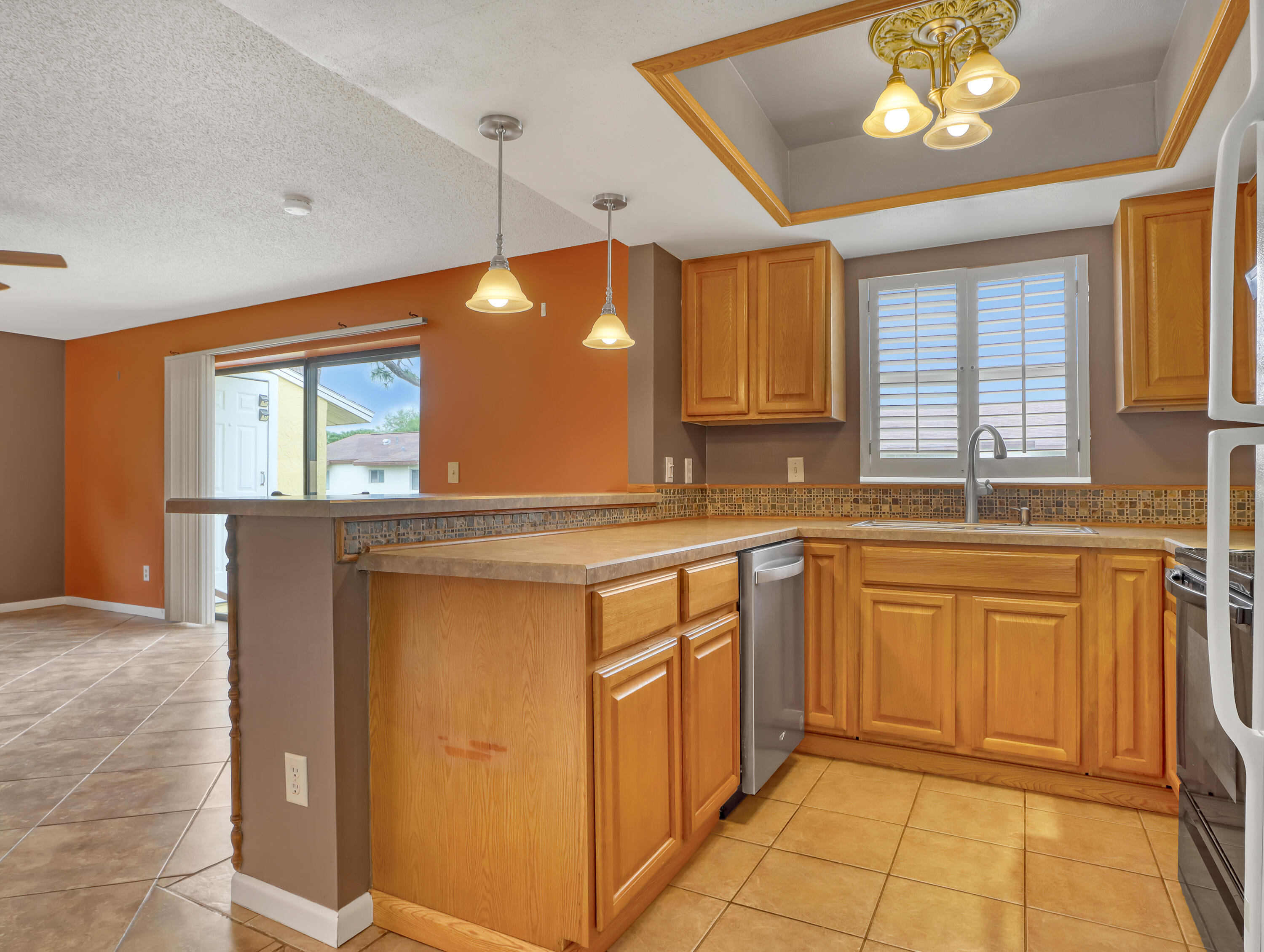 592 North Wickham Road, Unit 18 Melbourne, FL 32935 - Photo 13 of 29 a kitchen with granite countertop a sink cabinets and window