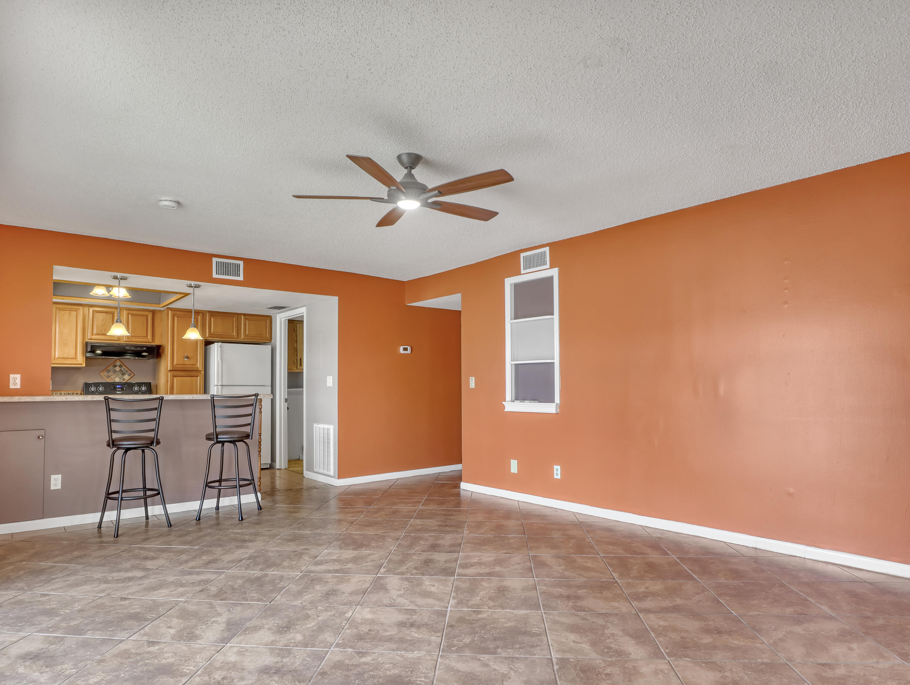 592 North Wickham Road, Unit 18 Melbourne, FL 32935 - Photo 9 of 29 a view of a livingroom with furniture and fan