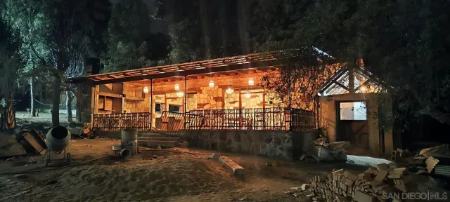 a view of a swimming pool with a yard and palm trees