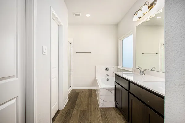 a bathroom with a sink a mirror and a shower