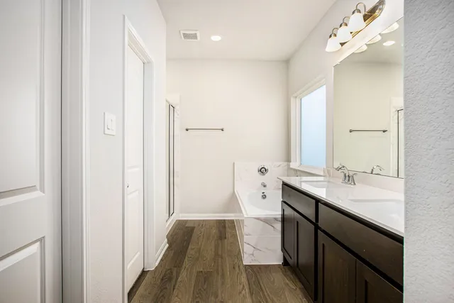 a bathroom with a sink a mirror and a shower