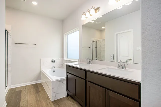 a spacious bathroom with a double vanity sink mirror and