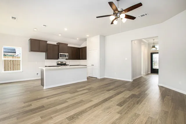 a view of kitchen with microwave and cabinets