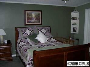 364 Sandburg Road Union Grove, NC 28689 - Photo 5 of 7 a bed sitting in a bedroom next to a lamp