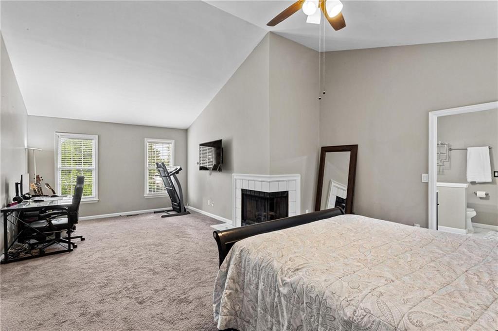 1996 Morning Walk Northwest Acworth, GA 30102 - Photo 14 of 22 a spacious bedroom with a bed and a chandelier