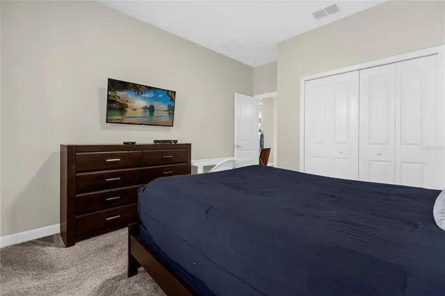 a bedroom with a bed and a dresser