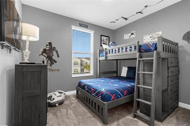 a bedroom with a bed and a chandelier