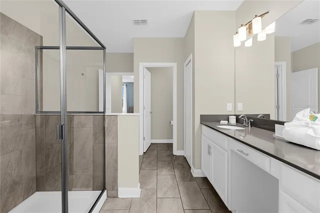 a bathroom with a toilet a sink and shower