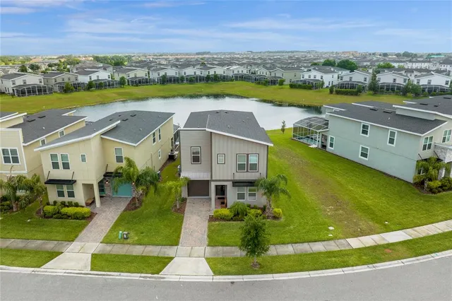 an aerial view of a house with a swimming pool yard and outdoor seating