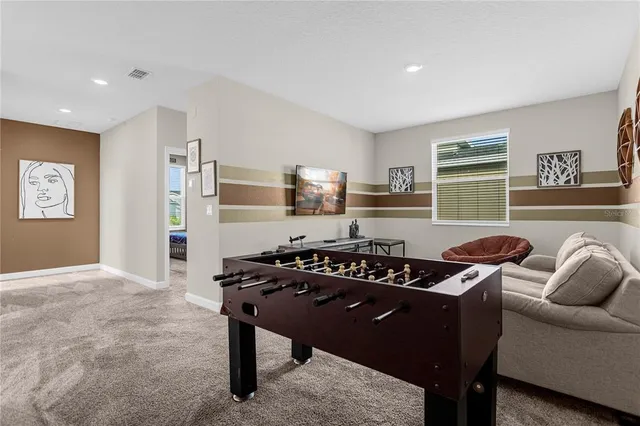 a spacious bedroom with a bed and chair