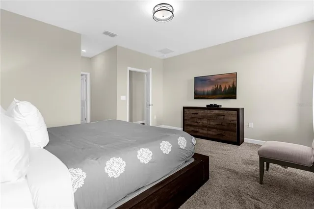 a bathroom with a granite countertop bathtub sink vanity mirror and toilet