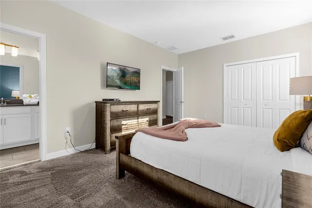 a bedroom with a bed and a couch