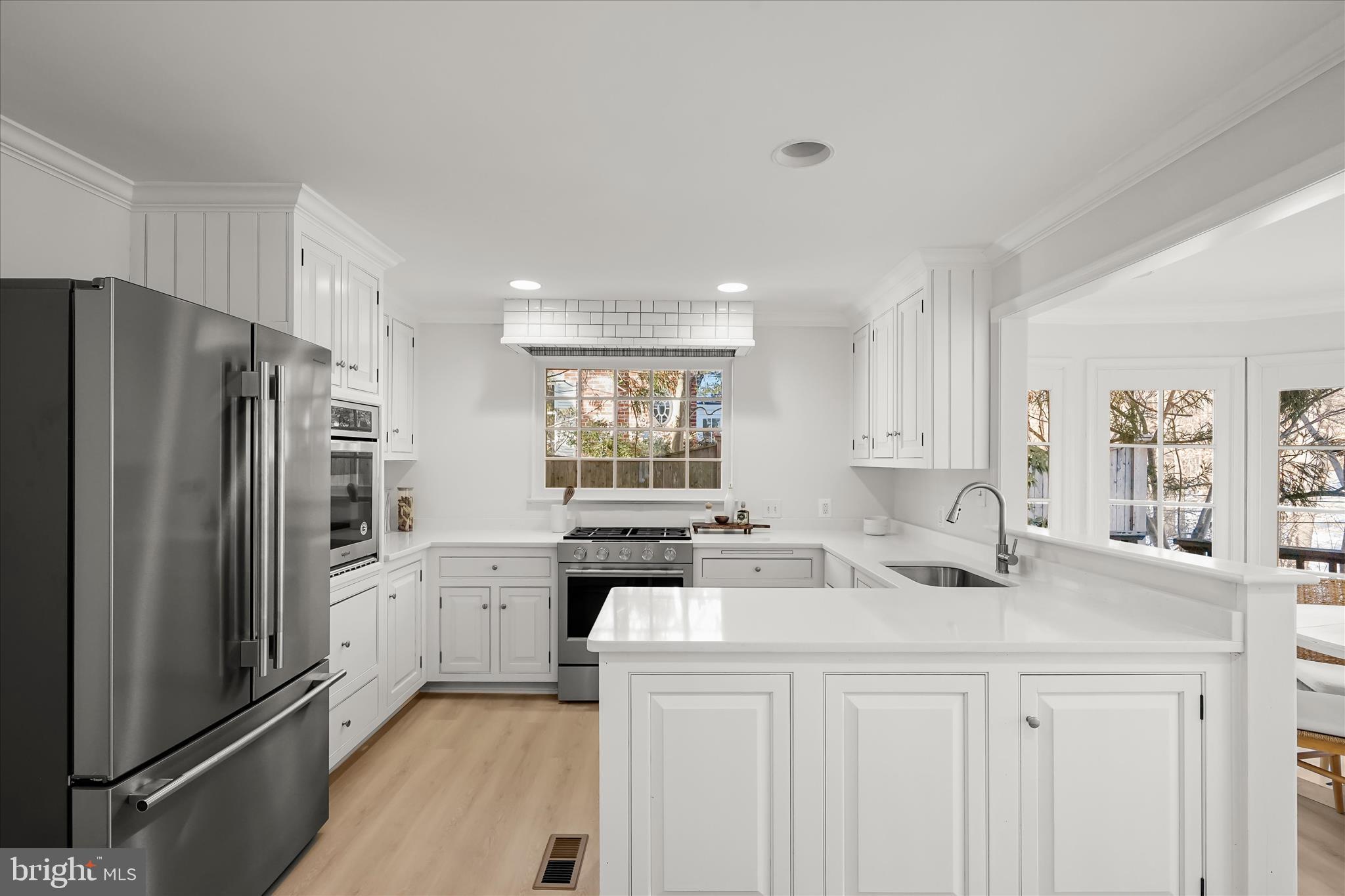 1727 Hoban Road Northwest Washington, DC 20007 - Photo 9 of 25 a kitchen with stainless steel appliances a refrigerator sink and cabinets