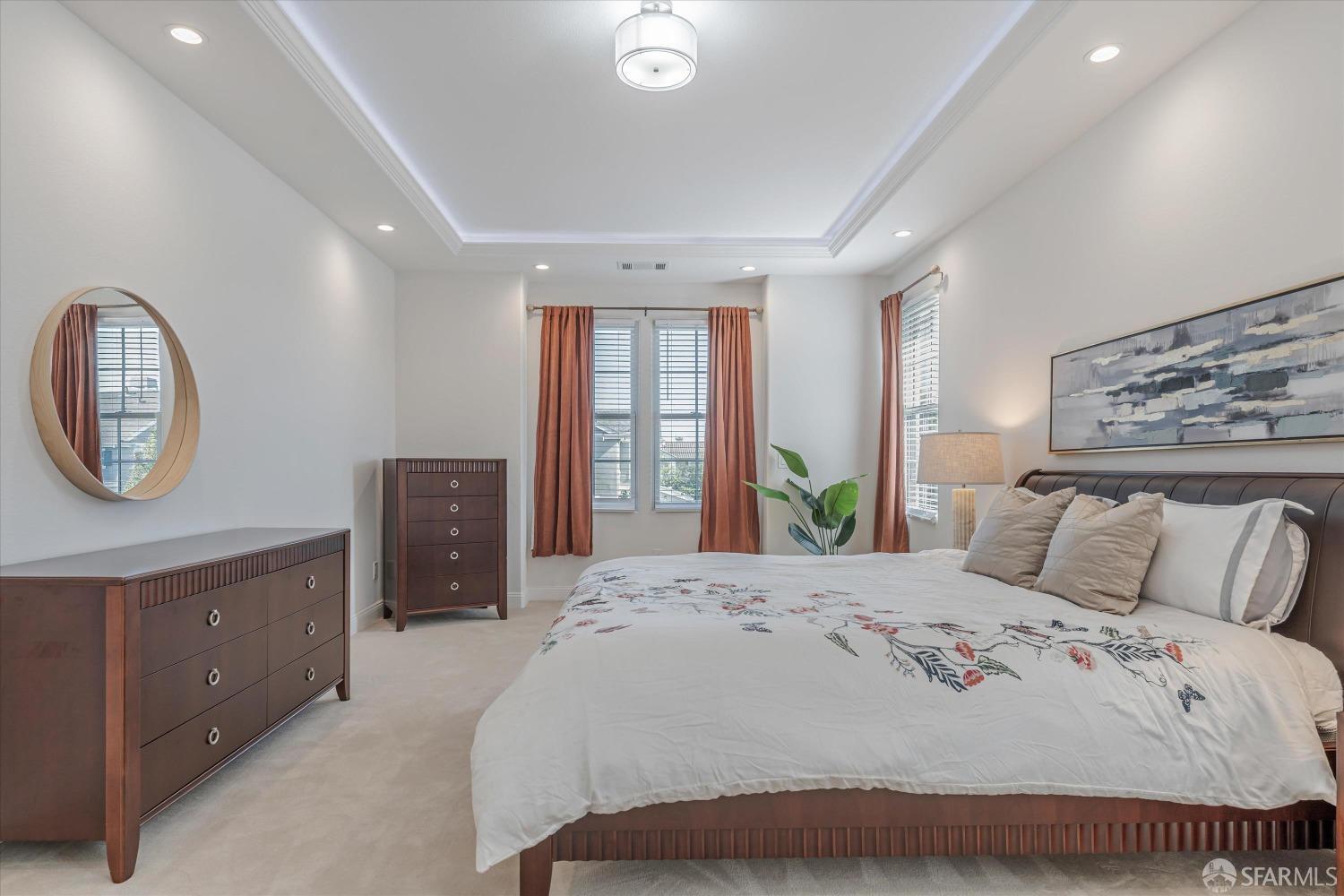 10 Jouett Square Alameda, CA 94501 - Photo 17 of 23 a bedroom with a bed a mirror on dresser and a window