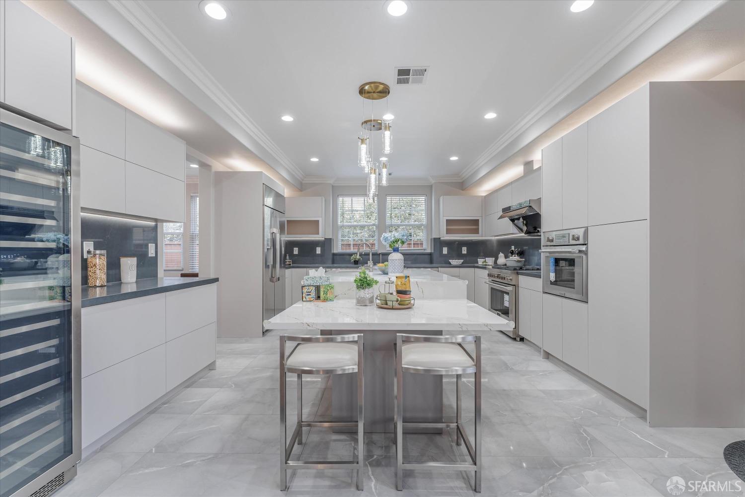 10 Jouett Square Alameda, CA 94501 - Photo 5 of 23 a kitchen with a dining table chairs wooden floor cabinets and stainless steel appliances