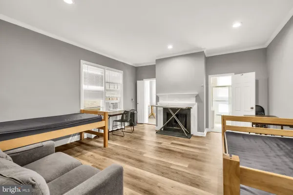 a living room with furniture and a dining table
