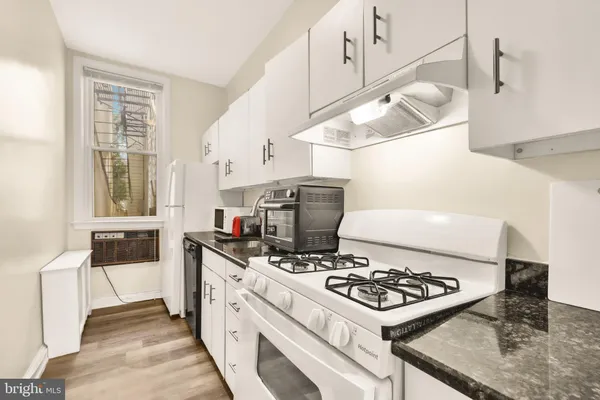 a kitchen with a stove and a sink