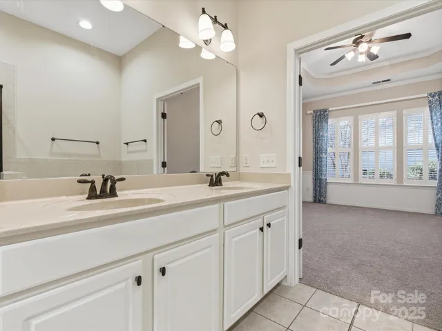 a spacious bathroom with a granite countertop sink a large mirror and shower