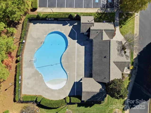 an aerial view of a house with swimming pool and outdoor seating
